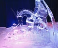 Ice sculpture of child and dragon, illuminated at night in Confederation Park