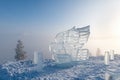 Ice sculpture of eagle. Winter landscape with a view of the Yakutsk city from the hill. The city is hidden under dense fog
