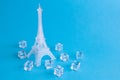 Ice sculpture of Eiffel tower and ice cubes abstract isolated on blue Royalty Free Stock Photo