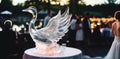 A ice sculpture of a swan spreading it\'s wings, a ornament centrepiece at a wedding reception