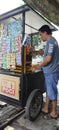 Ice seller in a cart on the side of the road, a popular small business that is perfect for hot weather