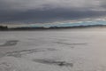 Ice sheets on the frozen lake Kirchsee in Upper Bavaria in winter with monastery Reutberg