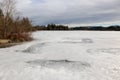 Ice sheets on the frozen lake Kirchsee in Upper Bavaria in winter with monastery Reutberg