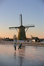 Ice skater in front of the Kinderdijk windmills Royalty Free Stock Photo