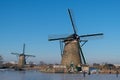 Ice skater on a frozen windmill canal at sunrise moment