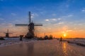 Ice skater silhouette on the frozen canal along the windmills alignment Royalty Free Stock Photo