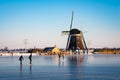 Ice skaters at a Dutch windmill Royalty Free Stock Photo