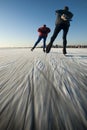 Ice skaters on a frozen lake.