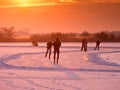 Ice skaters on a frozen lake