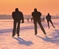 Ice Skaters on frozen lake at sunset Royalty Free Stock Photo