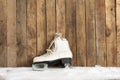 Ice skates against an weathered wooden wall Royalty Free Stock Photo