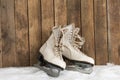 Ice skates against an weathered wooden wall Royalty Free Stock Photo