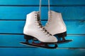 Ice skates on blue wooden background Royalty Free Stock Photo