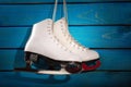 Ice skates on blue wooden background Royalty Free Stock Photo