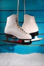 Ice skates on blue wooden background Royalty Free Stock Photo