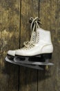 Ice skates hanging on an old weathered wooden wall Royalty Free Stock Photo