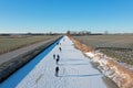 Ice skating on the canals in the countryside from the Netherlands in winter Royalty Free Stock Photo