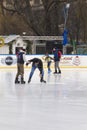 Helping a person to get up after falling on ice skating 