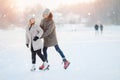 Ice skating lover couple having fun on snow winter holidays