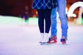 Ice skating lover couple having fun on snow winter holidays night illumination