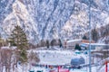 Ice skating rink between the snowy, wooded mountains. Winter. Translation: `Feel the energy of movement`