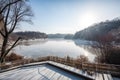 ice skating rink with view of frozen river, surrounded by picturesque winter landscape Royalty Free Stock Photo