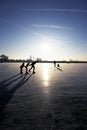 Ice skating at sunset in the Netherlands Royalty Free Stock Photo