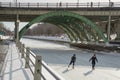 Ice skating under the bridge on the frozen Rideau Canal Ottawa W Royalty Free Stock Photo