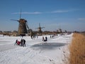 Ice skating between the windmills of Kinderdijk Royalty Free Stock Photo