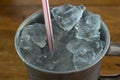 Ice in stanless glass with red straw