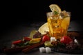 Ice tea in a glass on a black plate with biscuits, sweets and fruits on a black background Royalty Free Stock Photo