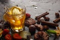 Ice tea in a glass on a black plate with biscuits, sweets and fruits on a black background Royalty Free Stock Photo