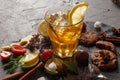 Ice tea in a glass on a black plate with biscuits, sweets and fruits on a black background Royalty Free Stock Photo