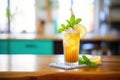 ice tea glass with lemon wedge and mint on a wooden table Royalty Free Stock Photo