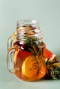 Ice Tea with Lemon Berry and Fresh Rosemary in Glass Jars Green Background Health Summer Drink Vertical