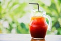 Ice tea on wooden table over green garden background Royalty Free Stock Photo