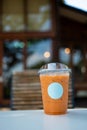 Ice Thai milk tea in a transparent plastic glass with empty white logo Royalty Free Stock Photo