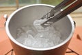 Ice tong used to pick cool ice cubes from steel bucket. concept of healthy and hygiene, summer party full of drinking liqueur Royalty Free Stock Photo