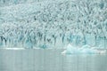 Ice wall and icebergs in Fjallsarlon glacier lagoon, abstract landscape Iceland