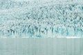 Ice wall and icebergs in Fjallsarlon glacier lagoon, abstract landscape Iceland