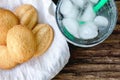 Ice and water in glass and ancient egg cakes in plate on wood stump