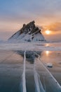 Ice water lake with rock peak mountain with sunset background, Baikal Russia