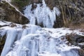 Ice waterfall formed along a mountain valley during a cold winter
