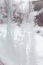 Ice on a window. Winter ice frost, frozen background. frosted window glass texture. Cold cool icicles background