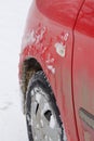 Ice on wing of car in winter. Snow stuck on wheel tire. Concept of dangerous driving in extreme cold and bad weather Royalty Free Stock Photo