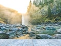 Ice wooden table with background of scenic view of water fall when sunset. Royalty Free Stock Photo