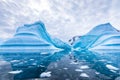 Iceberg in Antarctica floating in the sea, frozen landscape with massive pieces of ice reflecting on water surface, Antarctic