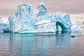 Iceberg in Antarctica, ice castle with Zodiac in front. Huge iceberg sculptured like fairytale castle Royalty Free Stock Photo