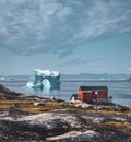 Iceberg with an arch in Antarctic Greenland waters against the backdrop of the mountains of the Arctic Peninsula. Small Royalty Free Stock Photo