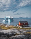 Iceberg with an arch in Antarctic Greenland waters against the backdrop of the mountains of the Arctic Peninsula. Small Royalty Free Stock Photo